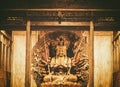 Golden Wood Statue of Guan Yin with thousand hands . Golden sculpture of Avalokiteshvara Buddha or Guanyin with thousand hands in